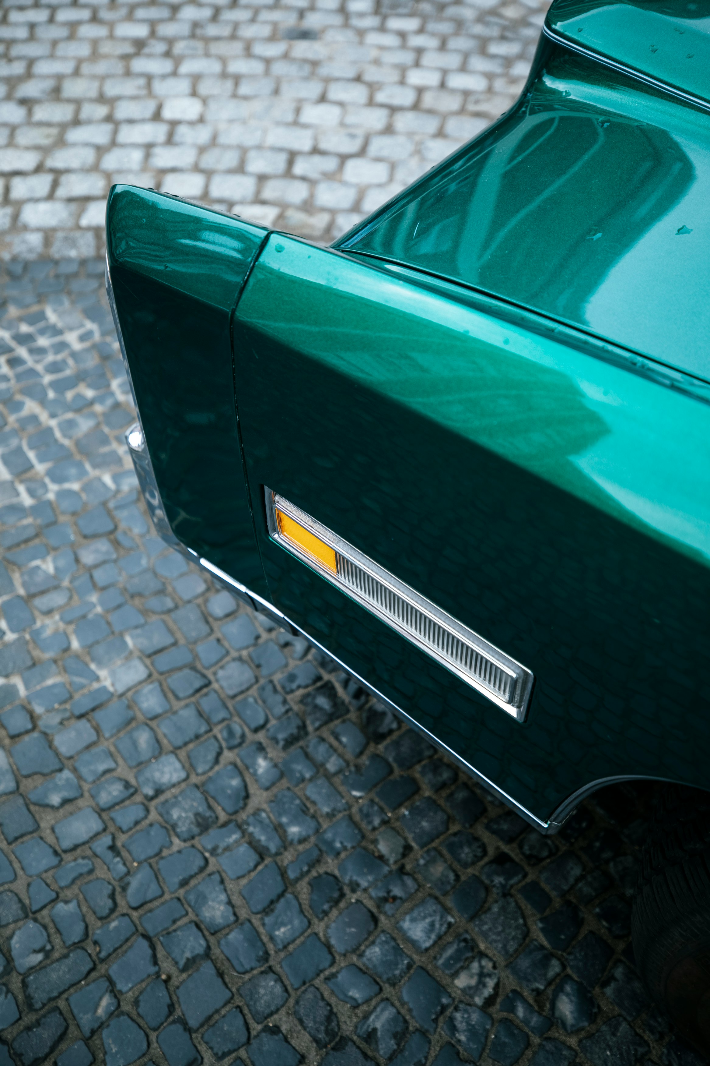 green car on gray concrete pavement